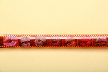Photo strip with lipstick kiss marks on yellow background