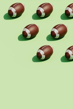 3d Rendering of several oval American football ball on a green.
