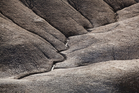 Water erosion carves clear hydrological pathways into the mancos shale badlands near Factory Butte, Utah.