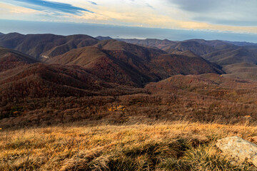 View of the ridge of mountain peaks from a height of 1000 m. View from Mount Peus to the peaks of the Caucasus Mountains.Mountain peaks of the Caucasus on a sunny day.