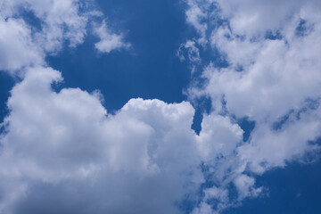 Hot tropical sunny day with blue sky covered with white clouds