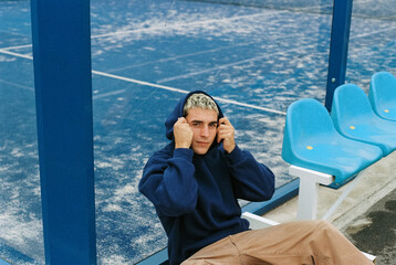 portrait of young man in blue hoodie 
