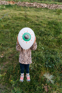 Kid with eye balloon in halloween