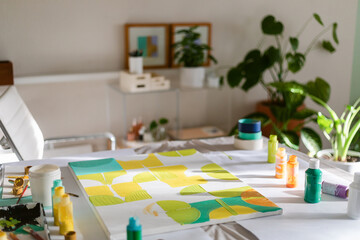 Painting on canvas with acrylic in painter's home studio