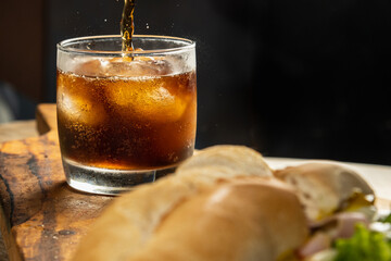 glass of refreshing cola soda or soda with selected focus