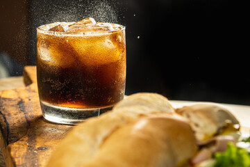 glass of refreshing cola soda or soda with selected focus