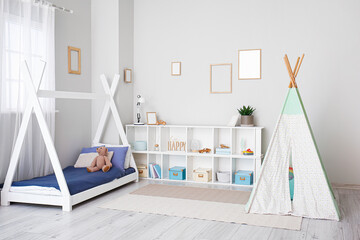Obraz na płótnie Canvas Stylish interior of children's room with baby bed