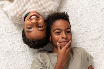 Two brothers lying on floor together