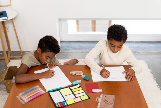 Two boys drawing after school at home