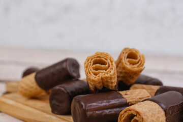 Heap of delicious wafer rolls on table, closeup