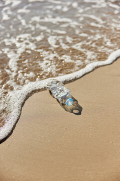 Plastic bottle near waving sea