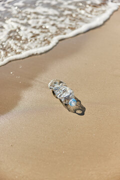 Plastic bottle near waving sea