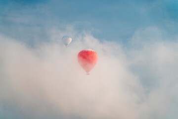 Hot air balloons in cloudy sky