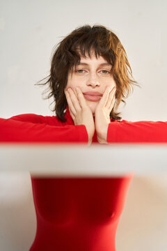 Brunette in turtleneck touching cheeks