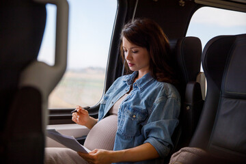 Woman analyzing documents while traveling in train