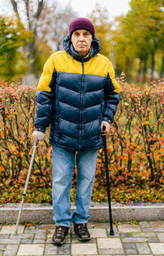 Disabled Senior man standing outdoors .