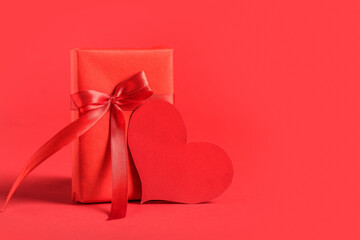 Gift box and blank card on red background. Valentine's Day celebration