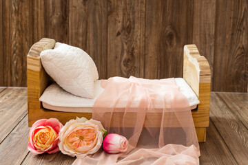 Newborn photo shoot set up with prop bed and wood backdrop