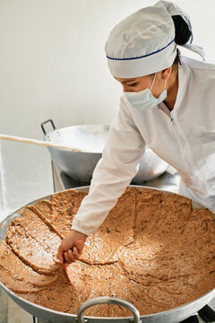Employee mixing dulce de leche
