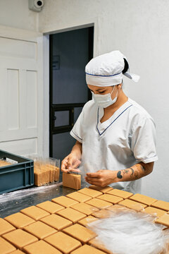 Operator packaging dulce de leche cheese