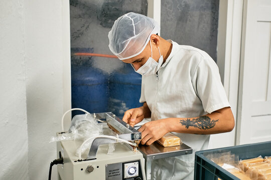 Operator packaging sweet milk cheese