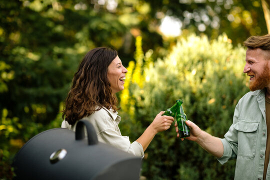 Man and Woman Toasting at Barbecue Party 
