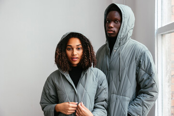 Confident couple standing together in studio