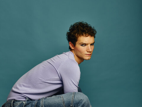 Male model sitting down and looking at camera