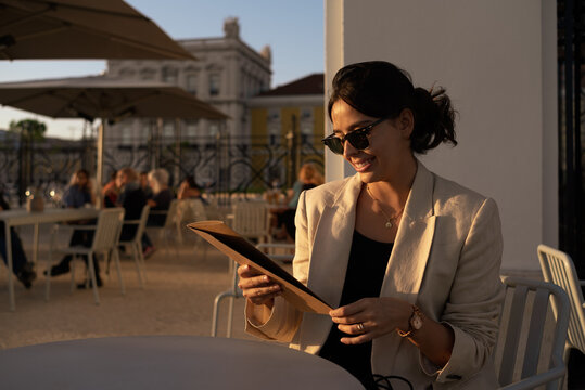 Sophisticated woman reading the menu 