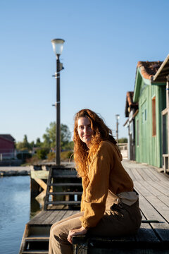 Woman sitting on pier