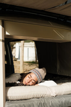 woman sleeping in a caravan bed