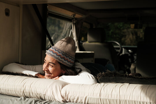 woman waking up in a caravan bed
