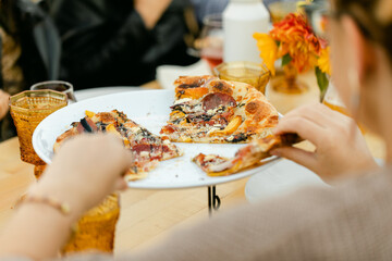 Dinner Party Guests Grab Slices of Artisan Pizza