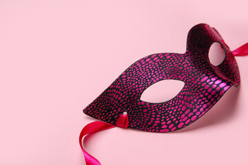 Beautiful carnival mask for Mardi Gras celebration on pink background, closeup