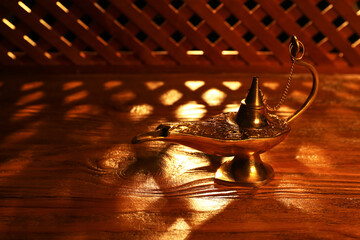 Aladdin lamp of wishes for Ramadan on wooden table