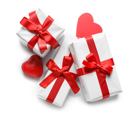 Gift boxes with beautiful bows and hearts isolated on white background. Valentine's Day celebration