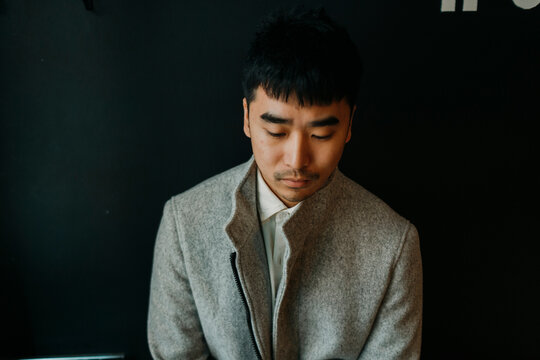 Portrait of elegant man over black background looking down