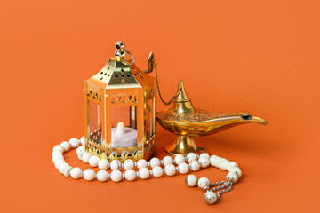 Aladdin lamp of wishes, Muslim lantern and prayer beads for Ramadan on red background