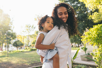 Loving Mom Carrying Her Daughter on the back