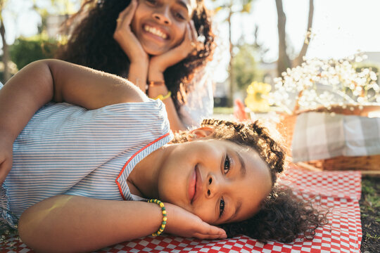 Daughter And Mom Lying Down In A Park