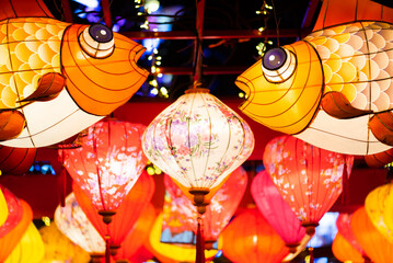 Multicolored Chinese lanterns illuminated at night low angle view for the Chinese new year - 564874443
