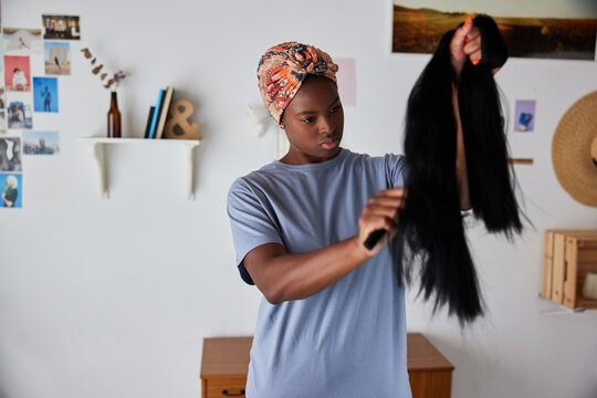 Woman brushing fake hair