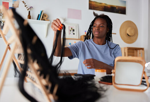 Woman braiding hair