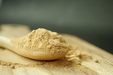 mixing brewers yeast flakes in a glass of water 