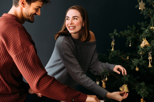 Couple Decorating Christmas Tree