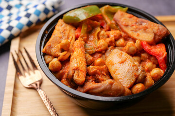 spicy chicken, rice and fresh vegetable salad on table.