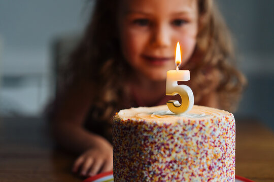 Colorful birthday cake with lit candle