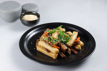 Gungjung Tteokbokki or Ddukbokki is Rice Cake, Slices Beef, and Various Vegetables Stir Fry with Soy Sauce.
