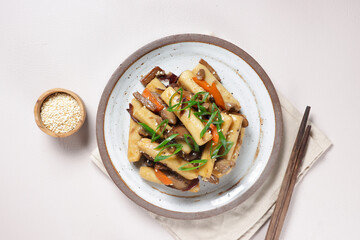 Gungjung Tteokbokki or Ddukbokki is Rice Cake, Slices Beef, and Various Vegetables Stir Fry with Soy Sauce.