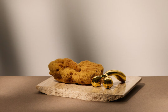 3D golden roller and sea sponge still life